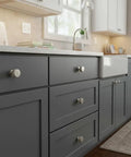 Top Shelf Slick Brushed Satin Nickel Cabinet Knobs With A Hardcore Knurled Shape And Seriously Heavy Duty Build on gray kitchen drawers.