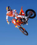 Motorcyclist performing stunt, illustrating use of Oil Change Kit 10W50 For Motorcycles 1.2L Ready To Race Bundle with Oil Filter and Crush Washer