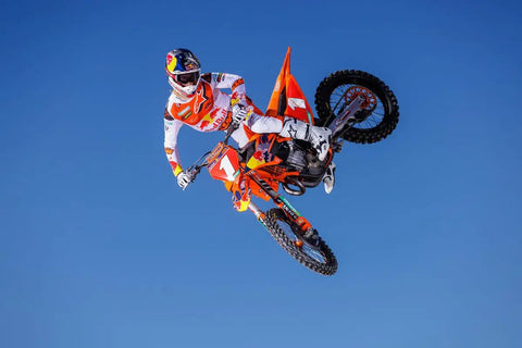 Motorcyclist performing stunt, illustrating use of Oil Change Kit 10W50 For Motorcycles 1.2L Ready To Race Bundle with Oil Filter and Crush Washer