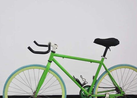 Green bike with Bullhorn Aluminum Alloy Handlebar 25.4mm By 390mm for fixed gear and road bikes, featuring 6061 aluminum bar.
