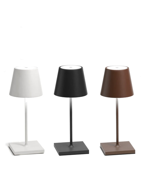 Three Poldina Pro Mini Rechargeable Wireless Table Lamps With Touch Control, in white, black, and brown, shown in a row.