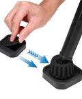 Hand placing Silicone Non Slip Caster Cups For Furniture Wheels under a black furniture leg, protecting floor