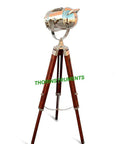 Chrome Spotlight Floor Lamp With Brown Wood Tripod Adjustable Height Studio Searchlight Lit Vintage Rustic Decor For Living Room Or Office Nautical Inspired Showpiece And Gift Idea, showing chrome spotlight on wooden tripod.