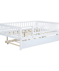 Full-Size Wood Daybed With Trundle And Fence Guardrails In White Finish showing rollout trundle and fence rails