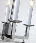 Close-up of chrome finish candle-style bulbs on Four Light Lantern Pendant with Industrial Geometric Steel Cage for foyer and dining room