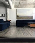 Real Deal Reclaimed Rustic Wood Stain Providing A Hella Smooth Water Based Finish That Reacts Naturally With Tannins To Create An Authentic Weathered Look Perfect For Interior Or Exterior Makeovers In A Convenient 55 Gallon Barrel applied in a modern living room with navy blue furniture.