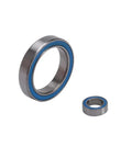 Close-up of two bearings from Blue Sealed Ball Bearing Kit, 26Pcs Full Set For RC Cars, Plug And Play With Granite Senton Typhon BLX 3S.