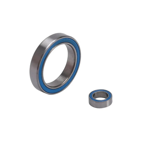 Close-up of two bearings from Blue Sealed Ball Bearing Kit, 26Pcs Full Set For RC Cars, Plug And Play With Granite Senton Typhon BLX 3S.