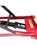 Side view of red steel-frame scissor lift table cart with hydraulic cylinder