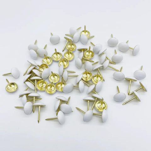 Hella Sturdy White Upholstery Tacks And Decorative Thumbtacks For Sofa Headboards And Furniture Trim with round white heads.