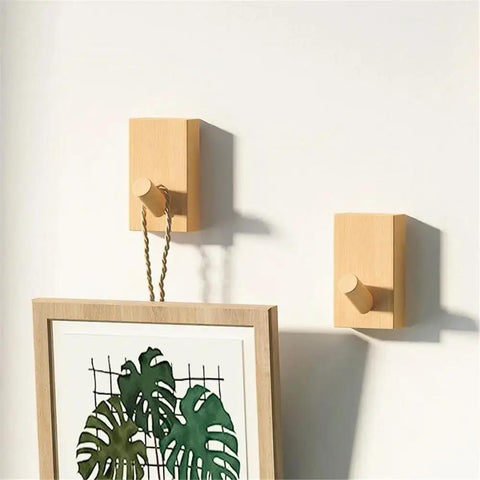 Modern Wall Mounted Coat Rack With Smooth Beige Finish sleek design holding a framed picture, showcasing entryway storage use.