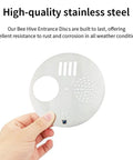 Hand holding a 4.92 inch stainless steel bee hive entrance disc, part of 4-Pack Stainless Steel Bee Hive Entrance Discs, Easy Install