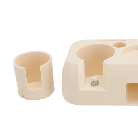 Heavy Duty Abs Coffee Tamper Station Built Tough For The Daily Grind with a portafilter holder and small cup.