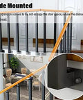 Close-up of side-mounted Heavy Duty Stair Railing Spindle System Kit with pre-drilled screws and wrought iron pillars in living space.