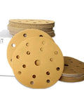 Heavy Duty 6 Inch Hook and Loop Sanding Discs With 15 Holes For Quick Dust Collection Aluminumoxide Abrasive Pads stacked on box.