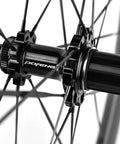 Close-up of Carbon Disc Wheelset 50C Tubeless hub with thru axle and Center Lock with black carbon spokes.