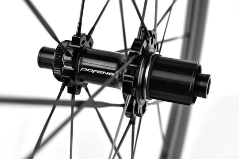 Close-up of Carbon Disc Wheelset 50C Tubeless hub with thru axle and Center Lock with black carbon spokes.