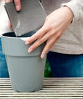Person repairing a cracked flower pot using Epoxy Repair Putty Stick 2 Oz Hand Mixable Two Part System All Purpose Quick Set Moldable Adhesive That Bonds To Damp Surfaces And Cures Underwater For Home Marine And Plumbing Fixes 1 Pack.