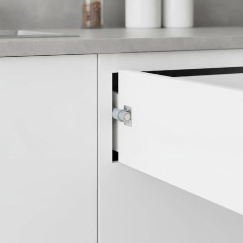 Push To Open Cabinet Latch Low Profile Gray Handleless Door Catch installed on a white kitchen cabinet.