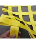 Close-up of Rock Solid Heavy Duty Lifting Sling Net With Rugged Nylon Webbing, showing yellow straps for secure towing.