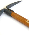 Close-up of Ergonomic Camp Heavy Duty Pick Mattock with Forged Railroad Track Steel head and wooden handle.