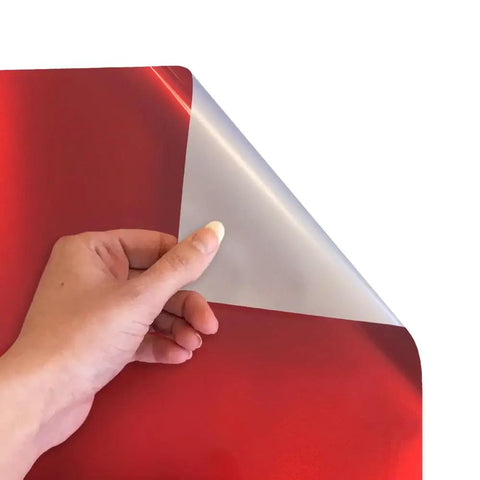 Hand holding electric red heat transfer vinyl roll, showcasing glossy finish for custom apparel projects. Electric Red Siser EasyWeed Heat Transfer Vinyl Roll 5 Feet.
