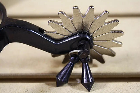 Close-up of Black Steel Western Jingle Bob Spurs for Men with slim band and two inch shank showing 16-point rowel