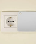 4 Pack Square Electrical Box Cover Plates For Blank Control Panels Or Junction Boxes next to a wall socket
