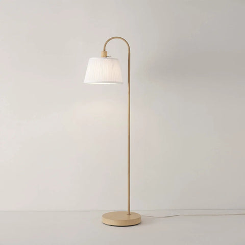 52 Inch Floor Lamp With Faux Wood Finish And White Pattern Shade Japandi Style Adjustable Arm On Off Rotary Switch Socket For Easy Operation Ideal Modern Living Room Light in a minimalist setting
