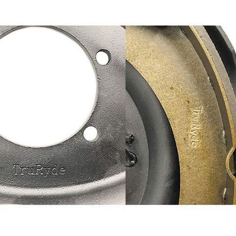 Split view of trailer brake kit: TrueRyde backing plate on left, bronze-colored brake shoe on right.