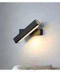 Elevate Your Home Vibe With This Sleek Black Metal Swivel Wall Sconce Led Lighting For Bedroom Living Room And Hallways Rustproof Adjustable Accent Lamp mounted on gray wall with soft glow.
