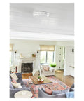 Ceiling-mounted sealed 10-Year Battery 2-In-One Smoke And Carbon Monoxide Detector With Slim Profile Design in a living room.