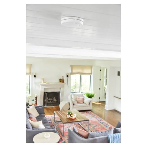 Ceiling-mounted sealed 10-Year Battery 2-In-One Smoke And Carbon Monoxide Detector With Slim Profile Design in a living room.
