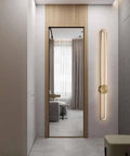 Slick Modern Wall Sconce Light Fixture Offering Three Color Temperatures And Built In Led Bulbs To Knock Your Socks Off While Setting The Ideal Cozy Vibe For Living Room Bedroom Hallway Bathroom Vanity And Simple Mount in a contemporary hallway with a mirror.