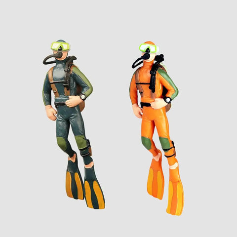 Two Pack Floating Diver Aquarium Decorations Cute Cartoon Fish Playmate That Glows In The Dark Includes Floating Balls And String For Easy Tank Setup Fun Kid Friendly Tank Accessories, featuring two resin divers in orange and green suits.