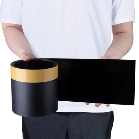 Person holding black roll and sheet of Under Couch Blocker Sofa Guard Sectional Connector Bumper That Stops Items From Sliding Under Furniture