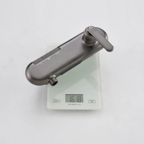 Piano Key Shower System Wall Mounted Exposed Gun Gray 3 in 1 valve body on a scale, showcasing its weight and design.