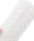 Close-up of 100 Pieces Clear Self Adhesive Cabinet Door Bumpers 0.4 Inch Diameter Rubber Dots on silicone sheet