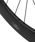 Close-up of Dope Carbon Fiber Road Bike Disc Brake Wheelset 700c Tubeless Ready 88mm deep rim, showing spokes and valve hole.