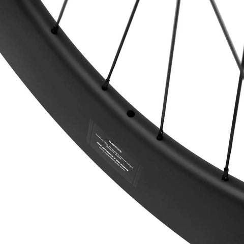 Close-up of Dope Carbon Fiber Road Bike Disc Brake Wheelset 700c Tubeless Ready 88mm deep rim, showing spokes and valve hole.