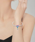 Hot Air Balloon Happy Birthday Dangle Charm In 925 Sterling Silver With Pink Purple And Blue Enamel on a woman's wrist