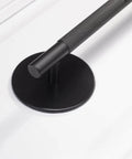 Close-up of a Matte Black Escutcheon Back Plate For Cabinet Knobs And Doors, installed with a handle, showing the round rosette plate.