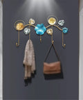 Rock Tight Wrought Iron Wall Hook For Sleek Nordic Style And Snug Door Storage That Locks In Keys Bags And Jackets Without A Sweat While Serving Heavy Duty Swag On Your Front Porch, featuring colorful hooks and wall decor.