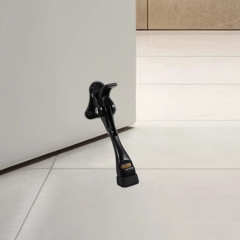 Adjustable Kick Down Door Stopper for Commercial and Home Doors installed on a white door with anti-collision protection.