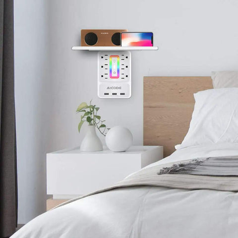 Wall Outlet Shelf With Night Light And 6 AC Outlets, 3 USB Ports, Surge Protector, in a bedroom setup next to bed.