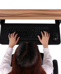 Rock Solid Retractable Keyboard Tray With Slick Pull Out Action For Effortless Typing And Plenty Of Mouse Space Totally Clutter Free Under Desk Office Essential Black, top view with hands on keyboard.