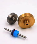 Front view of OmniJet III waterjet repair kit components: brass valve disk, steel disk, and blue spacer with rod