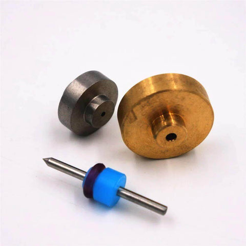 Front view of OmniJet III waterjet repair kit components: brass valve disk, steel disk, and blue spacer with rod