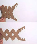 Hand holding DIY cardboard fish decor crafted with 1600 Piece Tiny Nails Wood Screws Set For DIY Crafts Antique Finish.