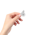 White Directional Caster Wheel PP 12pcs Inch for Furniture DIY held in hand, showcasing its compact design and swivel function.